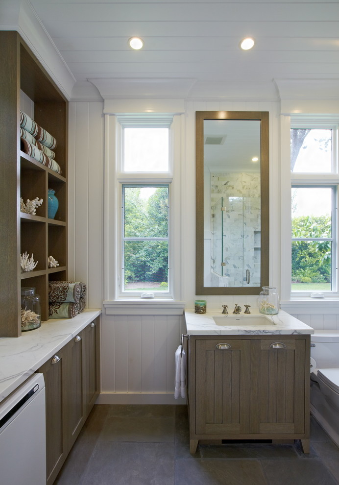 Ornate bathroom/laundry room photo in San Francisco with an undermount sink, shaker cabinets and medium tone wood cabinets