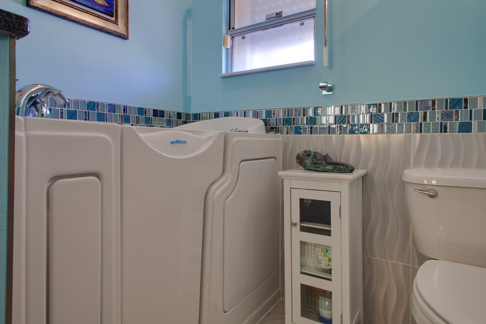 Photo of a medium sized traditional shower room bathroom in Tampa with flat-panel cabinets, white cabinets, a japanese bath, a corner shower, a two-piece toilet, multi-coloured tiles, mosaic tiles, blue walls, marble flooring, a submerged sink, granite worktops, grey floors and a hinged door.