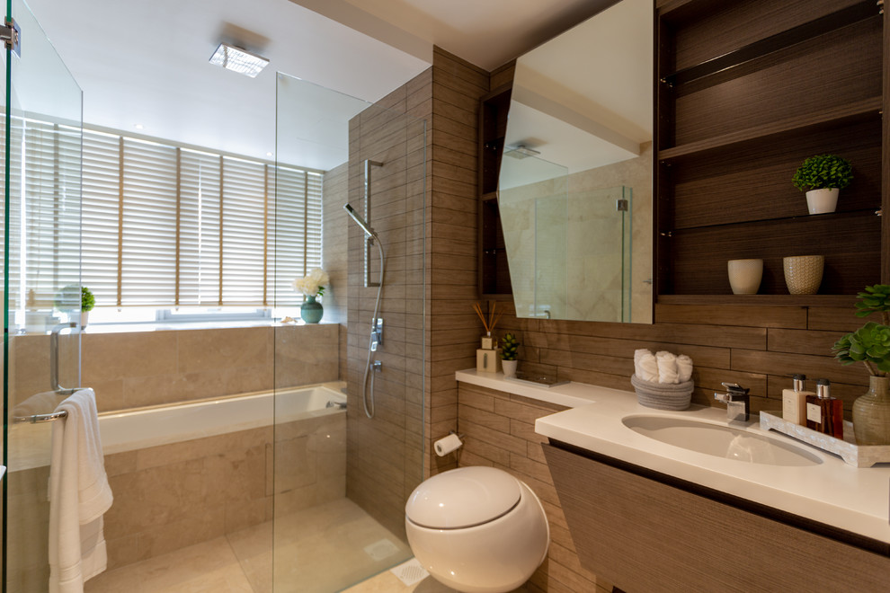 Photo of a contemporary bathroom in Singapore with flat-panel cabinets, medium wood cabinets, a submerged bath, a built-in shower, a wall mounted toilet, brown tiles, brown walls, a submerged sink, beige floors, a hinged door and white worktops.
