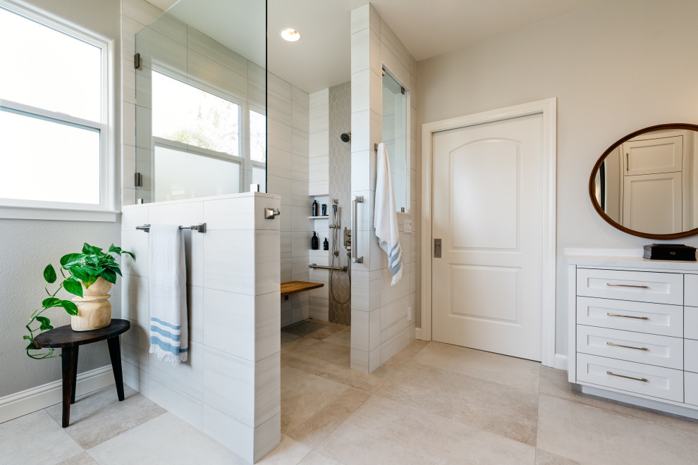 Example of a large trendy master gray tile and porcelain tile beige floor and porcelain tile bathroom design in Sacramento with recessed-panel cabinets, white cabinets, gray walls, a drop-in sink, white countertops and quartz countertops