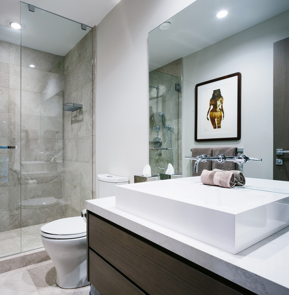 Medium sized contemporary shower room bathroom in Vancouver with flat-panel cabinets, dark wood cabinets, a double shower, a two-piece toilet, beige tiles, porcelain tiles, beige walls, medium hardwood flooring, a vessel sink, quartz worktops, grey floors and a hinged door.