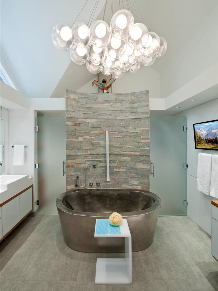 Design ideas for a large rustic ensuite bathroom in Denver with a vessel sink, flat-panel cabinets, white cabinets, a freestanding bath, a double shower, a one-piece toilet, grey tiles, porcelain tiles, white walls and porcelain flooring.