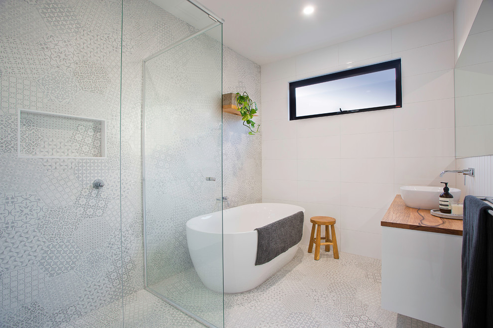 Design ideas for a medium sized contemporary bathroom in Melbourne with flat-panel cabinets, white cabinets, a freestanding bath, a corner shower, white tiles, white walls, a vessel sink, wooden worktops and a hinged door.