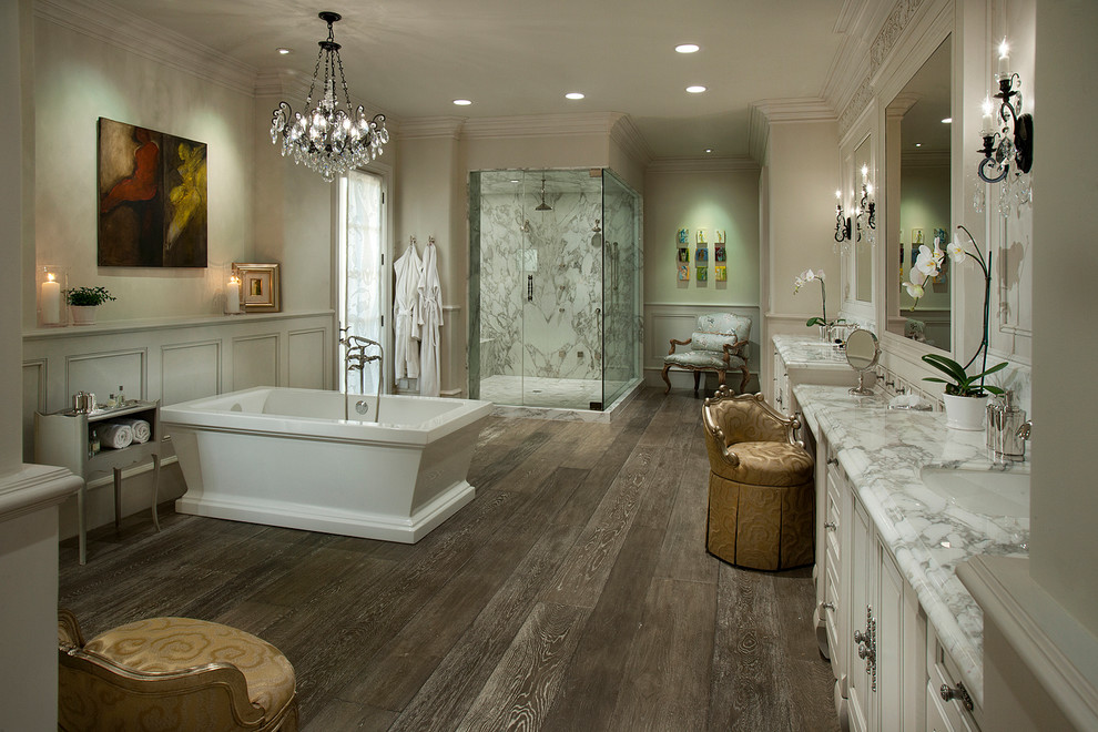 Example of a large transitional master white tile and porcelain tile dark wood floor bathroom design in Phoenix with raised-panel cabinets, white cabinets, a one-piece toilet, beige walls, marble countertops and an undermount sink