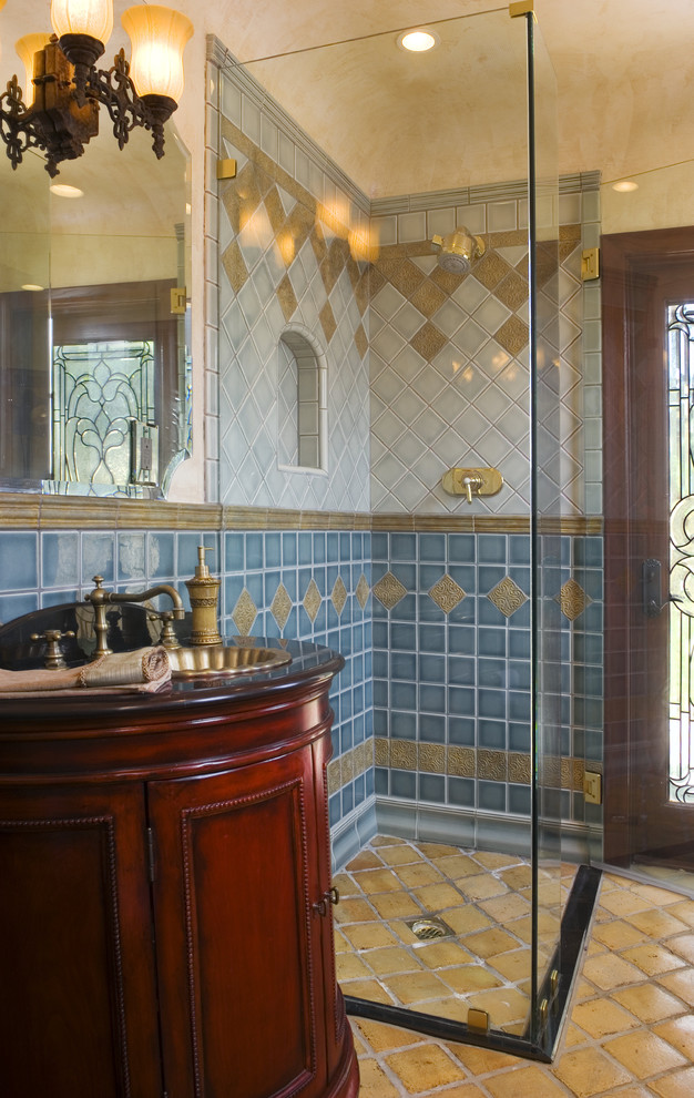 Example of a tuscan blue tile and ceramic tile alcove shower design in Los Angeles