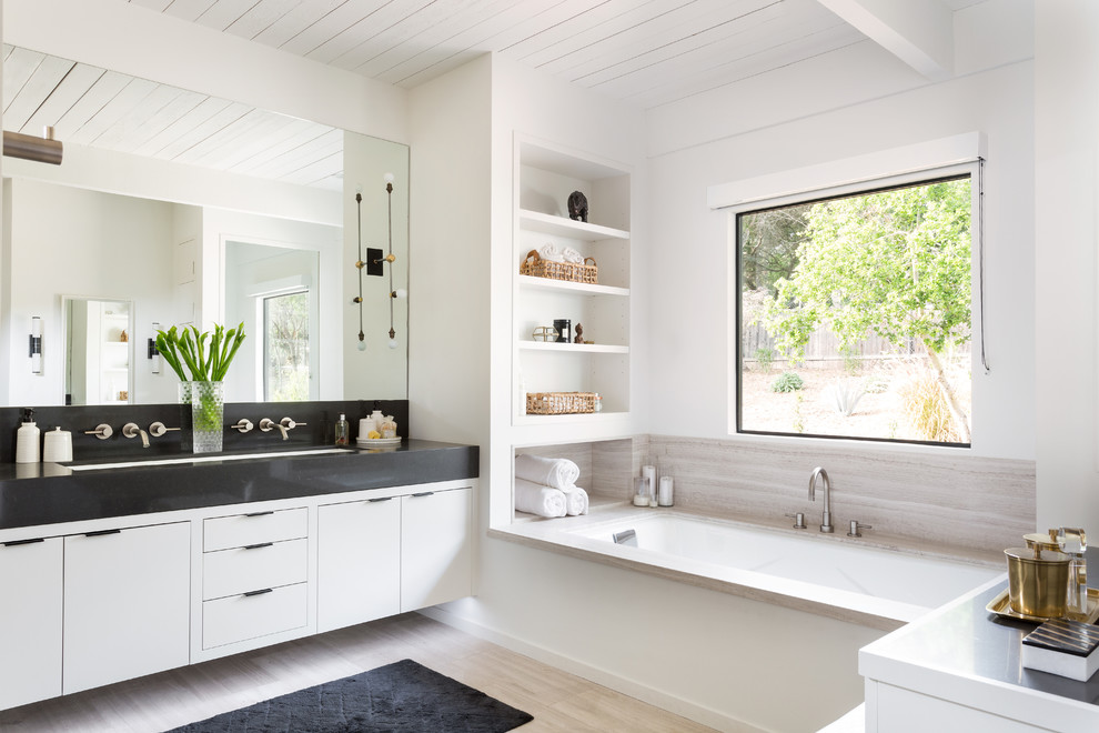 This is an example of an expansive retro ensuite bathroom in Santa Barbara with flat-panel cabinets, white cabinets, an alcove bath, white walls and a built-in sink.