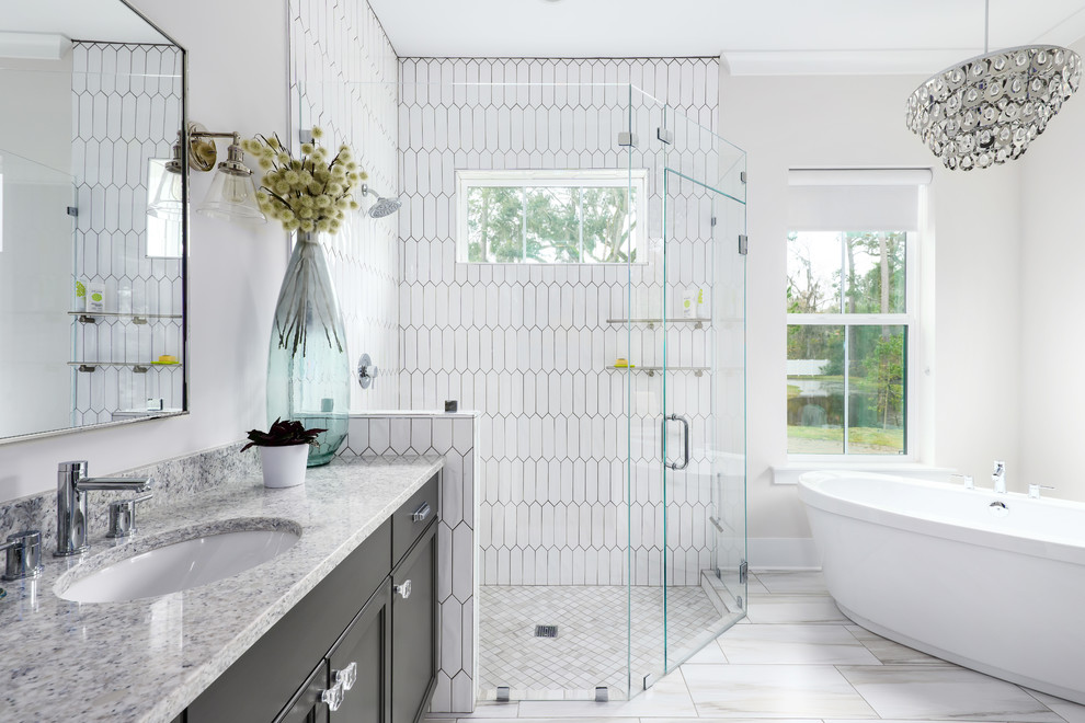 Bathroom - large cottage master white tile and ceramic tile porcelain tile and multicolored floor bathroom idea in Jacksonville with flat-panel cabinets, gray cabinets, a two-piece toilet, white walls, an undermount sink, quartz countertops, a hinged shower door and gray countertops