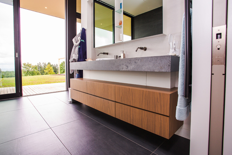 Bathroom - small modern 3/4 gray tile single-sink, cement tile floor and black floor bathroom idea in Portland with flat-panel cabinets, brown cabinets, concrete countertops, a floating vanity, a drop-in sink and gray countertops