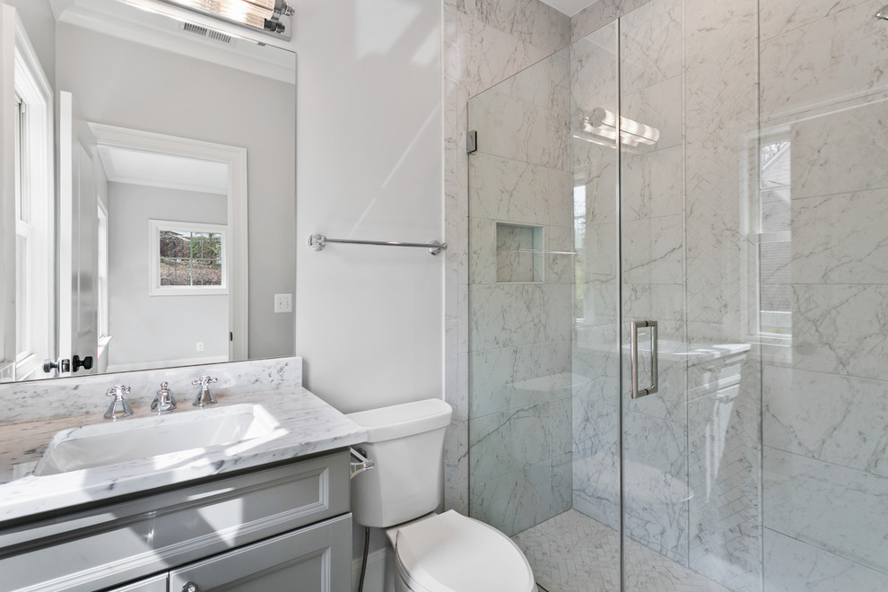 This is an example of a medium sized contemporary shower room bathroom in Other with shaker cabinets, grey cabinets, an alcove shower, a one-piece toilet, multi-coloured tiles, white walls, a submerged sink, a hinged door and multi-coloured worktops.
