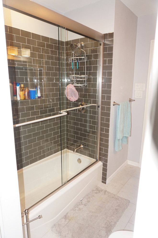 Photo of a medium sized classic shower room bathroom in Austin with recessed-panel cabinets, white cabinets, an alcove bath, a shower/bath combination, a two-piece toilet, black tiles, ceramic tiles, grey walls, travertine flooring, a submerged sink, granite worktops, beige floors and a sliding door.