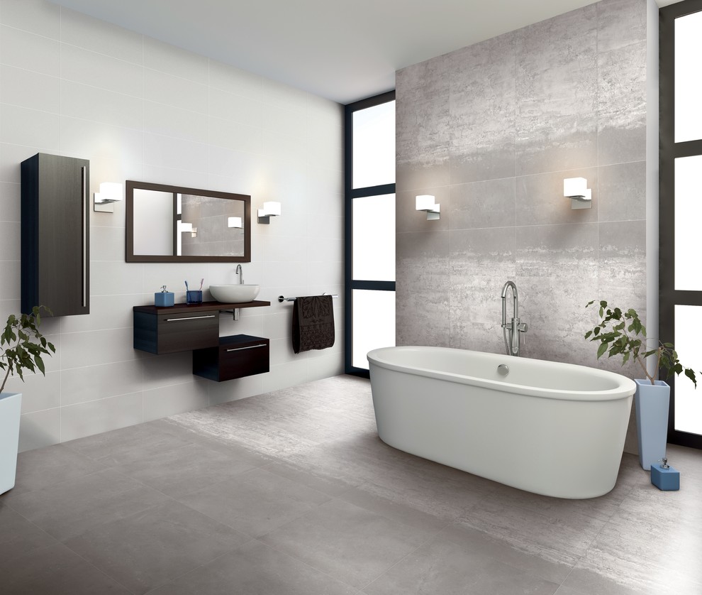 This is an example of a large modern ensuite bathroom in New York with flat-panel cabinets, dark wood cabinets, a freestanding bath, white walls, concrete flooring, a vessel sink, wooden worktops, grey floors and brown worktops.