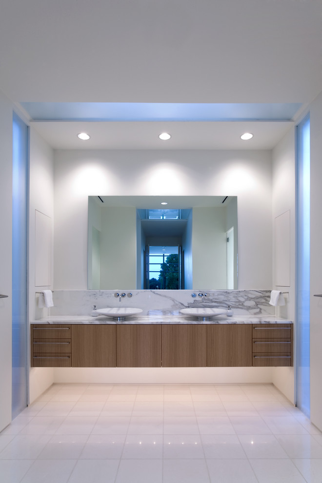 This is an example of a contemporary bathroom in Dallas with a vessel sink, flat-panel cabinets, medium wood cabinets and white walls.