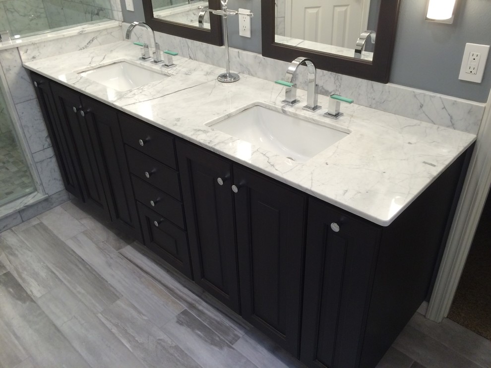 Mid-sized transitional master white tile and marble tile porcelain tile and gray floor bathroom photo in Houston with raised-panel cabinets, dark wood cabinets, marble countertops, gray walls and an undermount sink