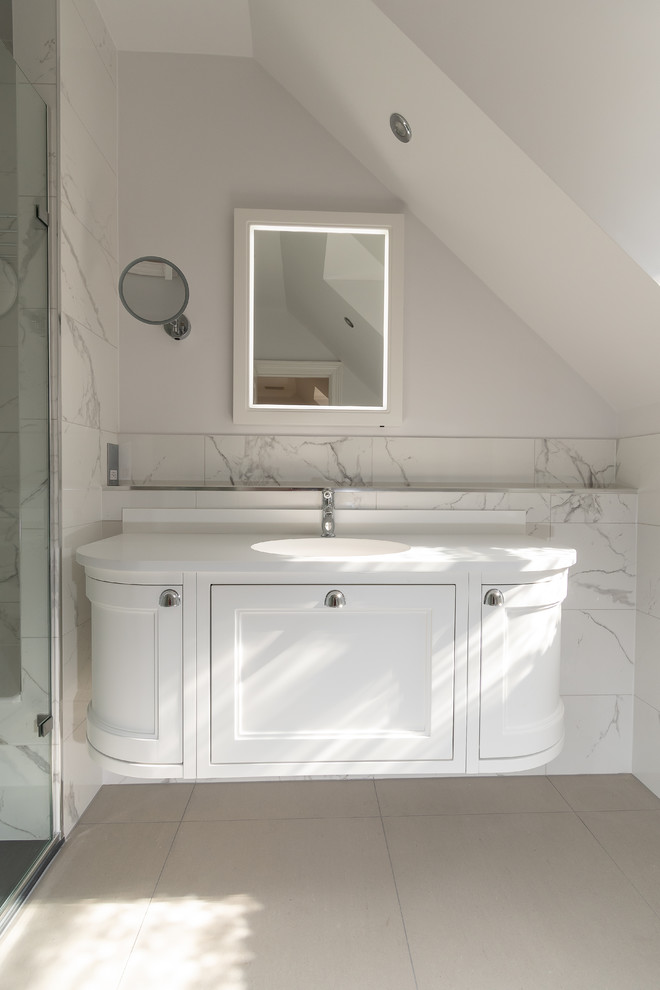 Photo of a medium sized classic shower room bathroom in Buckinghamshire with shaker cabinets, white cabinets, a walk-in shower, a wall mounted toilet, white tiles, porcelain tiles, white walls, porcelain flooring, an integrated sink, solid surface worktops, beige floors, a hinged door and white worktops.