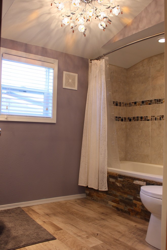 Ejemplo de cuarto de baño principal tradicional renovado pequeño con bañera encastrada, combinación de ducha y bañera, sanitario de dos piezas, baldosas y/o azulejos beige, baldosas y/o azulejos de porcelana, paredes púrpuras y suelo vinílico