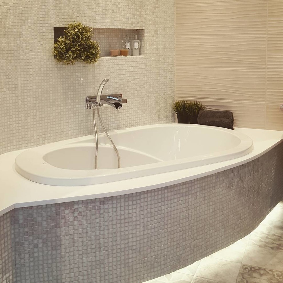 Example of a large minimalist master multicolored tile and porcelain tile porcelain tile and gray floor drop-in bathtub design in Toronto with flat-panel cabinets, light wood cabinets, multicolored walls, a drop-in sink and quartzite countertops