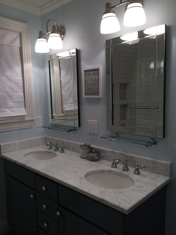 Medium sized classic ensuite bathroom in Nashville with a submerged sink, flat-panel cabinets, dark wood cabinets, marble worktops, a walk-in shower, white tiles, metro tiles and blue walls.