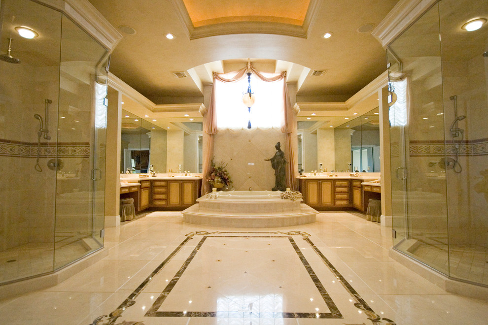 Expansive mediterranean ensuite bathroom in Las Vegas with raised-panel cabinets, medium wood cabinets, a built-in bath, an alcove shower, marble flooring, beige floors and a hinged door.
