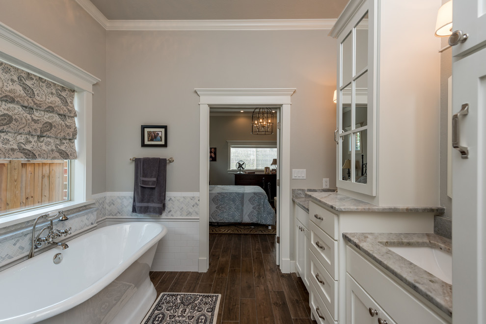 Example of a mid-sized arts and crafts master white tile and porcelain tile ceramic tile and brown floor bathroom design in Other with a two-piece toilet, gray walls, a drop-in sink, granite countertops and a hinged shower door