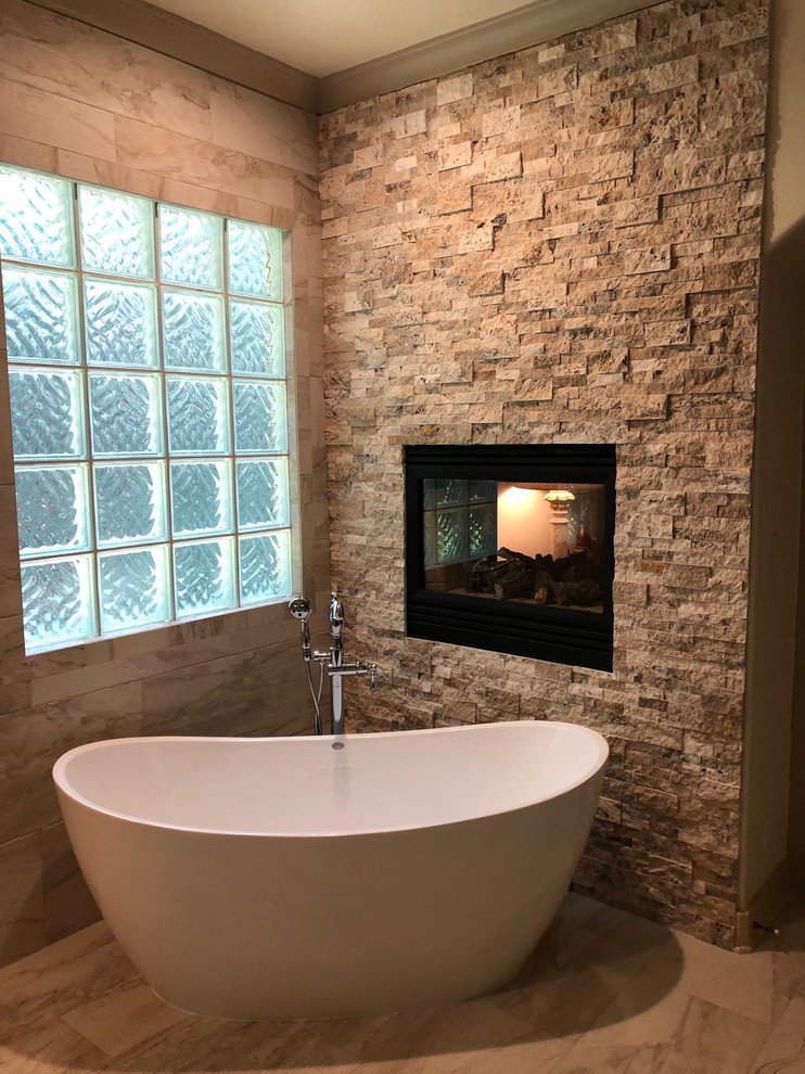 Inspiration for a large mediterranean ensuite bathroom in Houston with a freestanding bath, a built-in shower, brown tiles, ceramic tiles, ceramic flooring, brown floors and an open shower.
