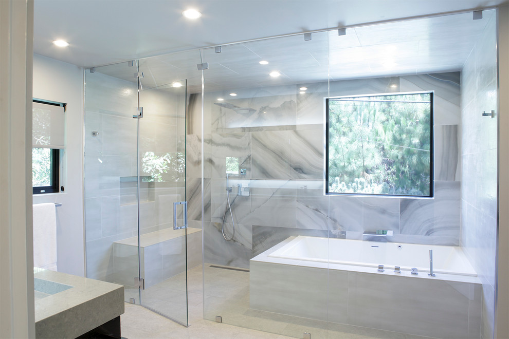 Drop-in bathtub - large modern master gray tile and porcelain tile porcelain tile drop-in bathtub idea in San Diego with flat-panel cabinets, dark wood cabinets, quartz countertops and gray walls
