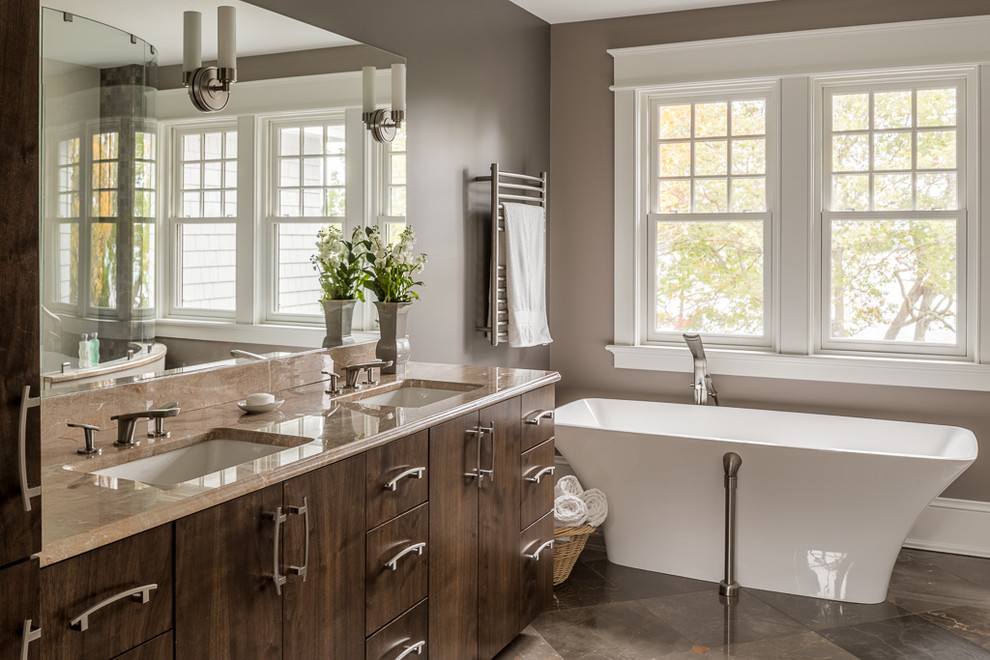 Design ideas for a large classic ensuite bathroom in Portland Maine with flat-panel cabinets, dark wood cabinets, a freestanding bath, brown walls, a submerged sink, grey floors, a corner shower and a hinged door.
