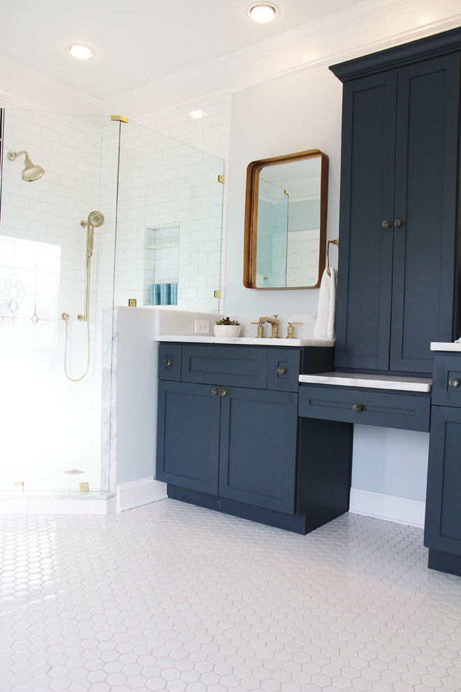 This is an example of a large victorian ensuite bathroom in Atlanta with shaker cabinets, blue cabinets, a claw-foot bath, a corner shower, a two-piece toilet, white tiles, metro tiles, blue walls, mosaic tile flooring, a submerged sink and quartz worktops.