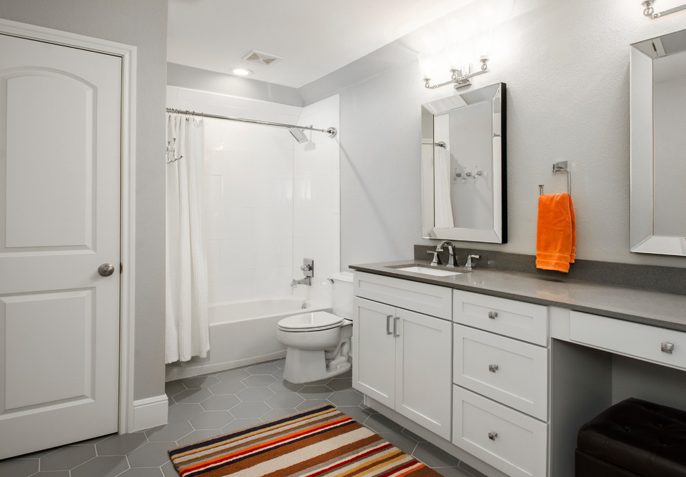 Example of a mid-sized transitional kids' white tile and ceramic tile porcelain tile and gray floor bathroom design in Dallas with flat-panel cabinets, white cabinets, a two-piece toilet, gray walls, an undermount sink, quartz countertops and gray countertops