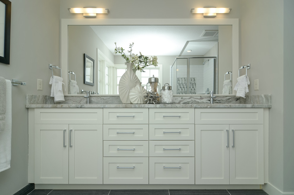 Inspiration for a country bathroom in Minneapolis with shaker cabinets, white cabinets, a freestanding bath, a corner shower, grey tiles and grey walls.