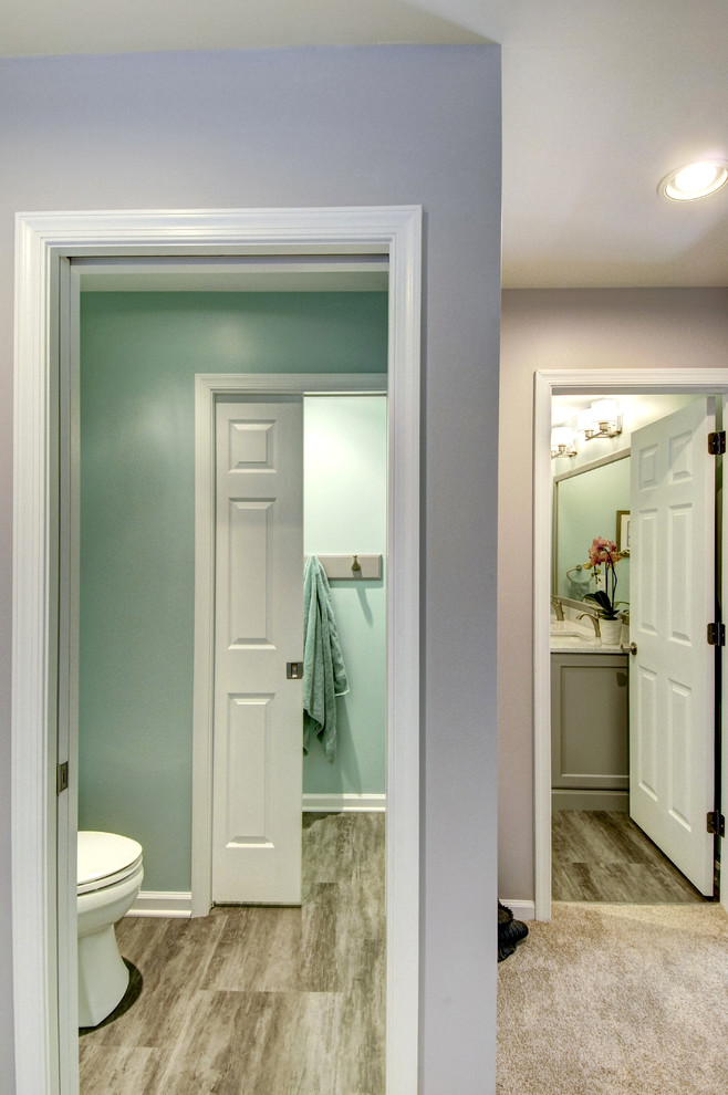 Example of a mid-sized classic ceramic tile and brown floor bathroom design in Philadelphia with recessed-panel cabinets, gray cabinets, a one-piece toilet, green walls, an undermount sink and quartz countertops