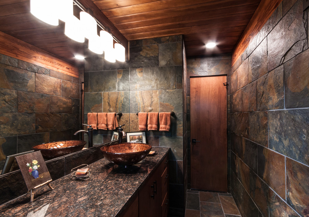 Bathroom - mid-sized rustic slate tile and multicolored tile slate floor and multicolored floor bathroom idea in Other with flat-panel cabinets, medium tone wood cabinets, a one-piece toilet, a vessel sink, granite countertops and multicolored walls