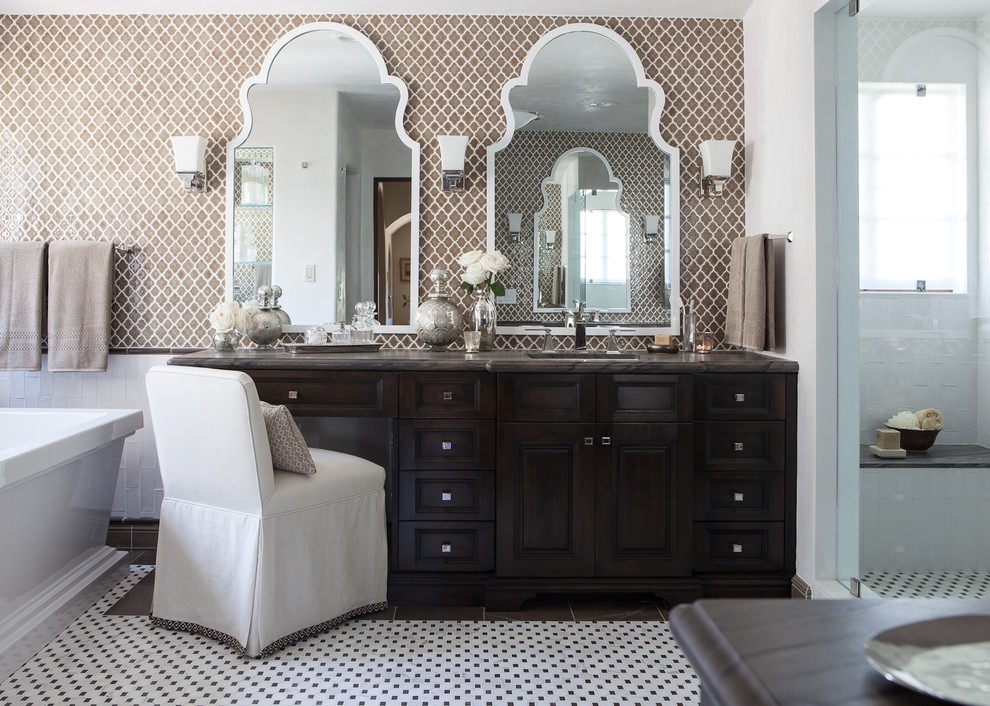 Design ideas for a medium sized traditional ensuite bathroom in Los Angeles with brown tiles, ceramic tiles, raised-panel cabinets, dark wood cabinets, a freestanding bath, brown walls and mosaic tile flooring.