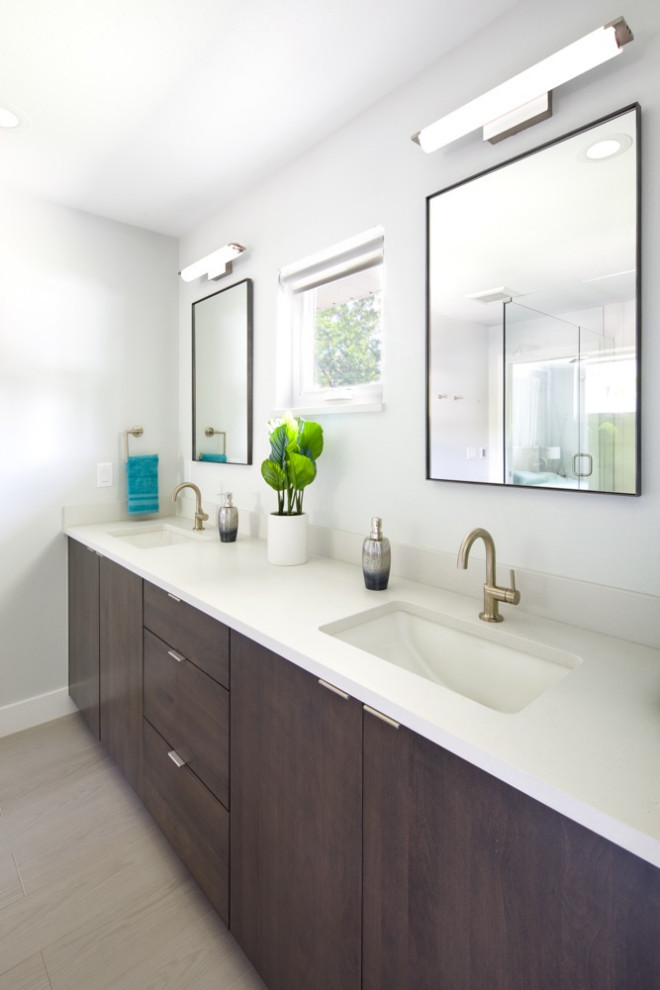 This is an example of a medium sized contemporary ensuite wet room bathroom in Denver with flat-panel cabinets, dark wood cabinets, a one-piece toilet, blue tiles, ceramic tiles, white walls, a built-in sink, granite worktops, a hinged door and white worktops.