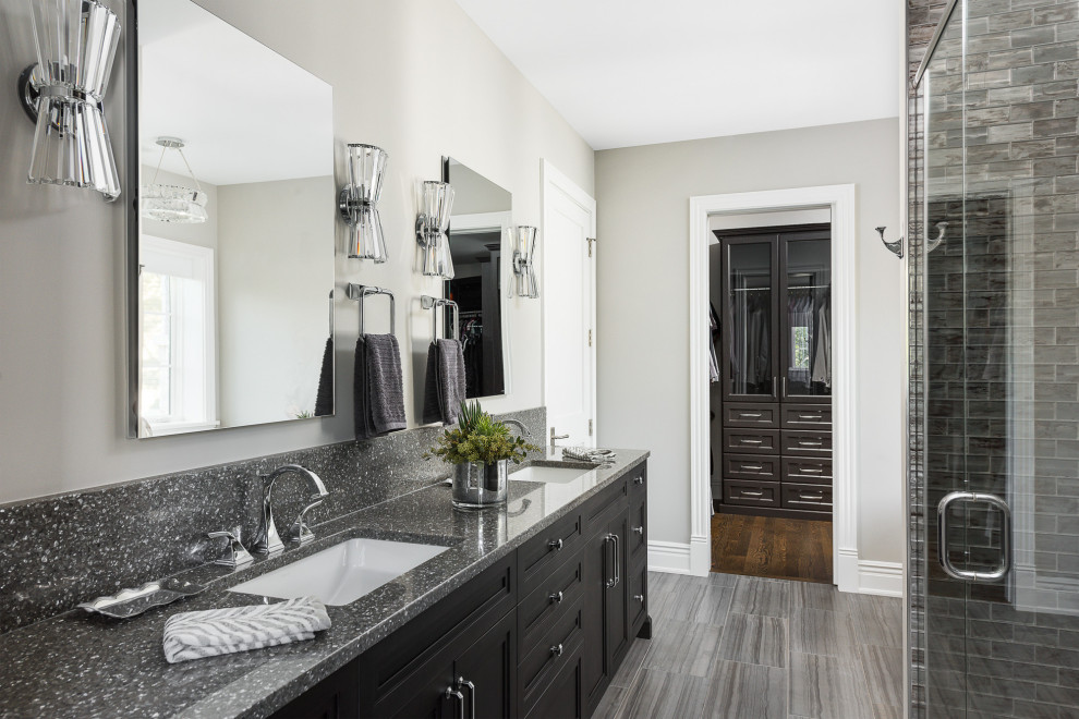 Example of a transitional master gray tile porcelain tile and gray floor bathroom design in Chicago with shaker cabinets, black cabinets, gray countertops, gray walls and an undermount sink