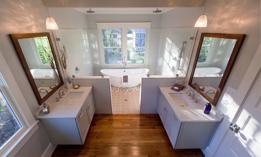 Inspiration for a large traditional ensuite bathroom in Raleigh with shaker cabinets, grey cabinets, a freestanding bath, a double shower, grey walls, medium hardwood flooring and a submerged sink.