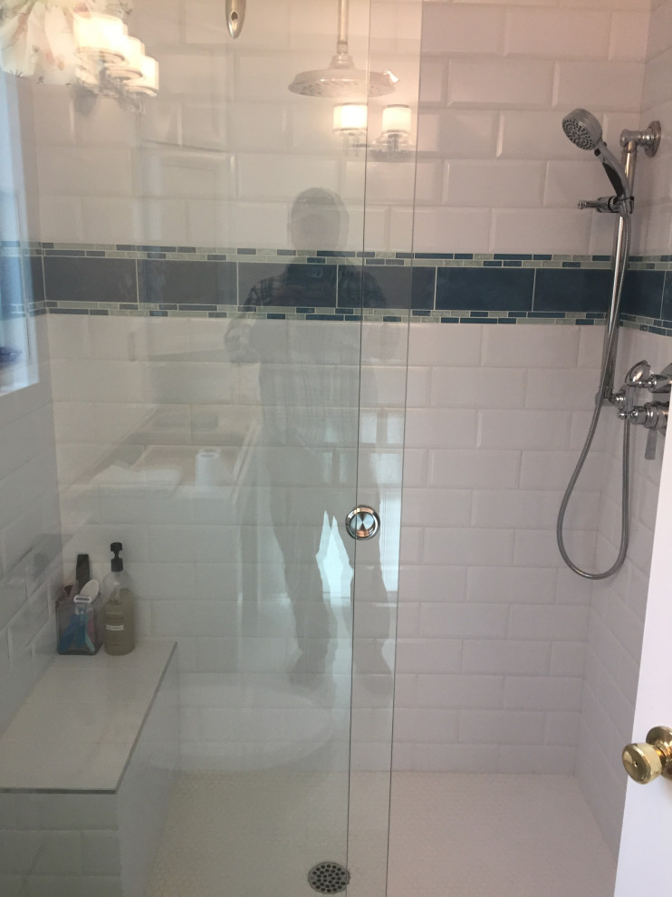 Example of a mid-sized master white tile and subway tile marble floor, white floor and double-sink bathroom design in Phoenix with raised-panel cabinets, white cabinets, a one-piece toilet, beige walls, a drop-in sink, quartz countertops, gray countertops, a niche and a freestanding vanity