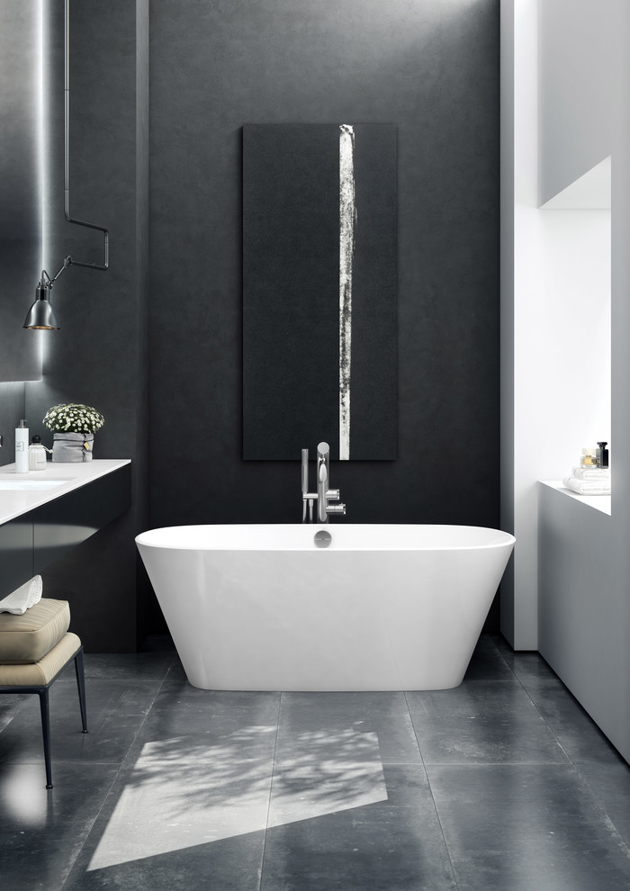 Example of a mid-sized trendy master concrete floor and black floor freestanding bathtub design in Charleston with flat-panel cabinets, black cabinets, black walls, an undermount sink and quartz countertops