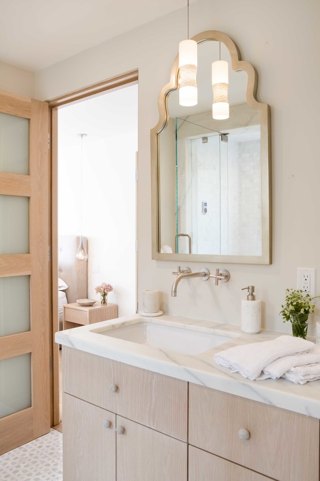 Photo of a traditional bathroom in Orange County with flat-panel cabinets, light wood cabinets, white walls and a submerged sink.