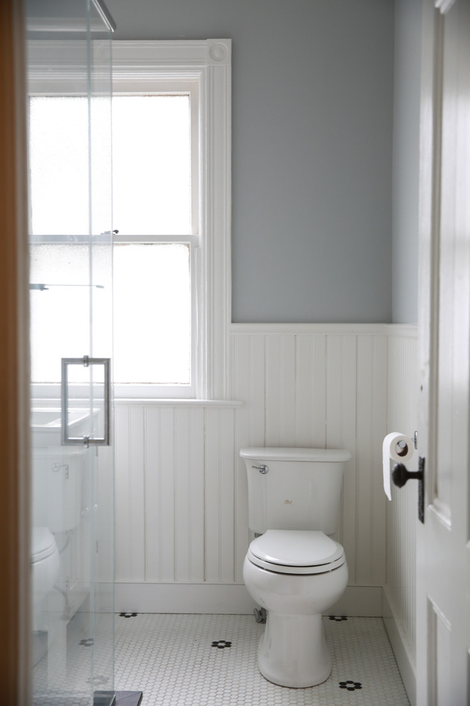 Inspiration for a medium sized victorian shower room bathroom in Boston with white cabinets, a corner shower, a two-piece toilet, white tiles, ceramic tiles, grey walls, ceramic flooring, an integrated sink, multi-coloured floors, a hinged door and white worktops.