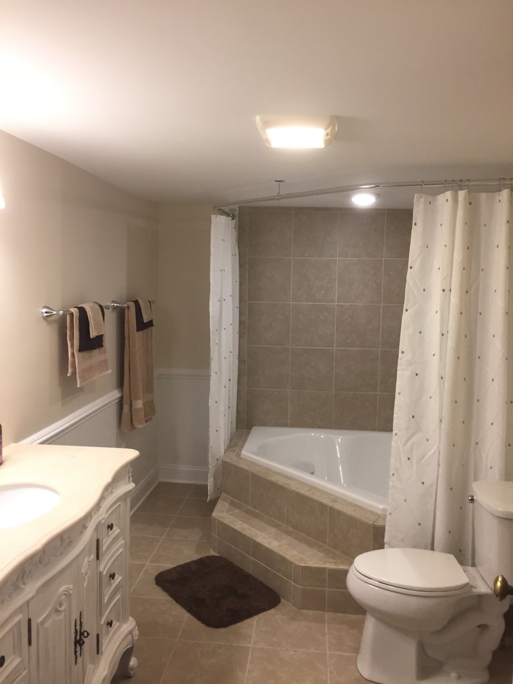 Large victorian ensuite bathroom in Other with freestanding cabinets, white cabinets, a built-in bath, a shower/bath combination, beige tiles, porcelain tiles, beige walls, porcelain flooring, a submerged sink, marble worktops, beige floors and a shower curtain.