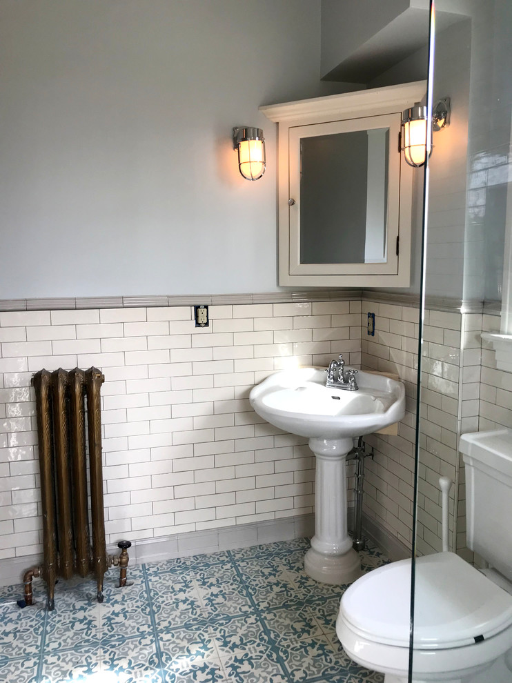 Стильный дизайн: главная ванная комната среднего размера в викторианском стиле с фасадами в стиле шейкер, белыми фасадами, ванной на ножках, душевой комнатой, раздельным унитазом, белой плиткой, керамической плиткой, синими стенами, полом из цементной плитки, раковиной с пьедесталом, синим полом и открытым душем - последний тренд