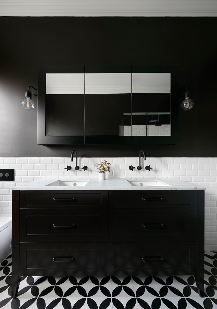 Large retro ensuite bathroom in Melbourne with freestanding cabinets, black cabinets, a freestanding bath, a walk-in shower, metro tiles, mosaic tile flooring, an integrated sink, marble worktops and multi-coloured floors.