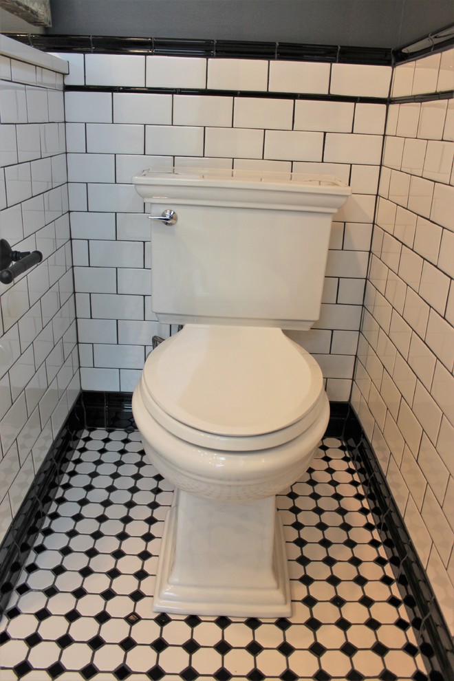 Inspiration for a medium sized victorian ensuite bathroom in Indianapolis with freestanding cabinets, black cabinets, a two-piece toilet, white tiles, grey walls, a submerged sink, engineered stone worktops, a hinged door, white worktops, ceramic tiles, porcelain flooring and multi-coloured floors.
