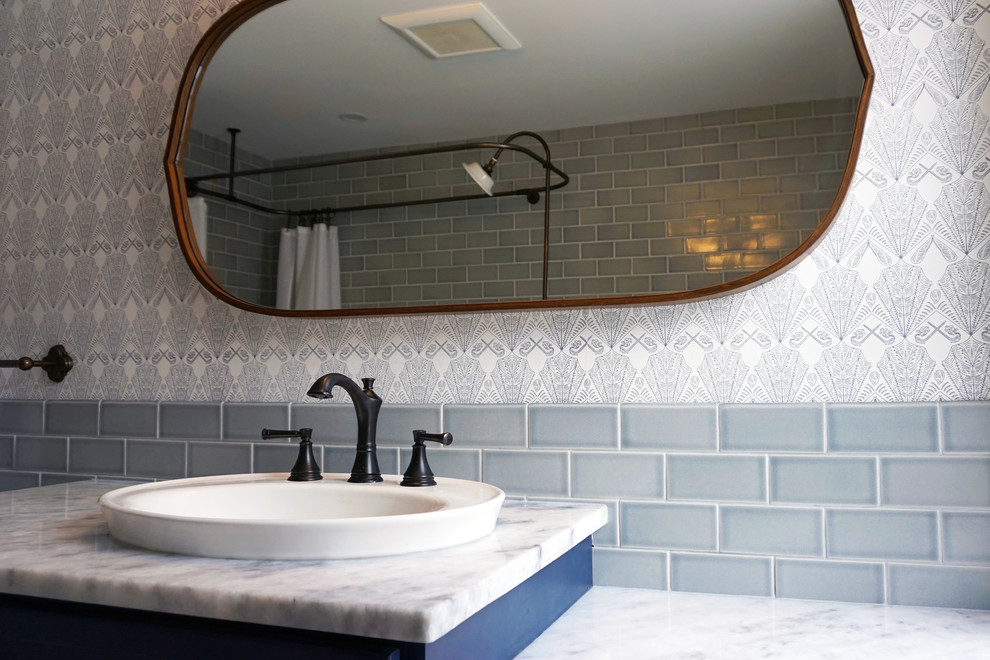 Medium sized victorian ensuite bathroom in Philadelphia with blue cabinets, a claw-foot bath, grey tiles, ceramic tiles, grey walls, ceramic flooring, marble worktops, grey floors and white worktops.