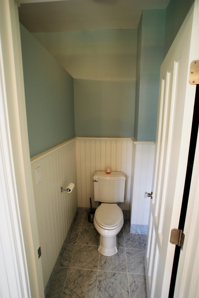 Inspiration for a medium sized victorian ensuite bathroom in Other with raised-panel cabinets, white cabinets, a claw-foot bath, an alcove shower, a two-piece toilet, white tiles, stone tiles, white walls, marble flooring, an integrated sink, solid surface worktops, grey floors, a hinged door and white worktops.