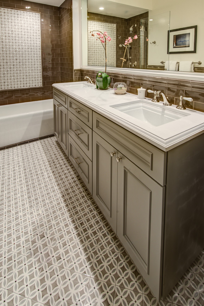 Mid-sized elegant master brown tile and porcelain tile mosaic tile floor bathroom photo in San Francisco with an undermount sink, recessed-panel cabinets, gray cabinets, quartz countertops, a one-piece toilet and brown walls