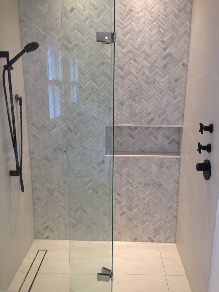 Photo of a medium sized contemporary grey and white bathroom with freestanding cabinets, grey cabinets, a built-in bath, a walk-in shower, grey tiles, mosaic tiles, marble worktops and a hinged door.