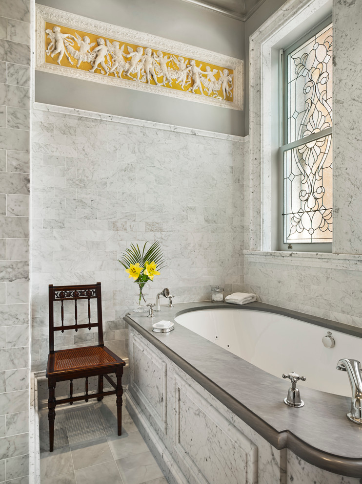 На фото: большая главная ванная комната в викторианском стиле с полновстраиваемой ванной, мраморным полом и серыми стенами