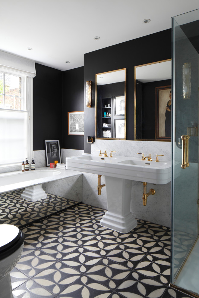 Photo of an eclectic bathroom in London with flat-panel cabinets, a built-in bath, a built-in shower, black walls, cement flooring, a pedestal sink, black floors, a hinged door, grey tiles, marble tiles and white worktops.