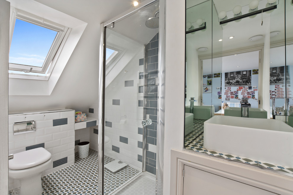 Photo of a small classic family bathroom in Oxfordshire with recessed-panel cabinets, white cabinets, a corner shower, grey tiles, white tiles, metro tiles, white walls, a vessel sink, multi-coloured floors, a hinged door and multi-coloured worktops.